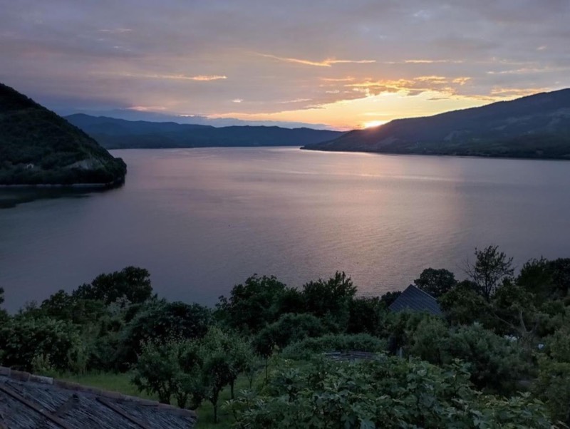 Sunset over the Danube, seen from the garden of Vila Hedona, wooded hills on both sides